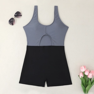 Flat lay of color-block one-piece swimsuit with cutout and black boyshort bottoms