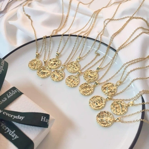 Golden 18K titanium steel zodiac coin necklaces featuring intricate embossed patterns
