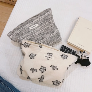 Handmade minimalist canvas clutch and makeup bags with butterfly print and textured fabric