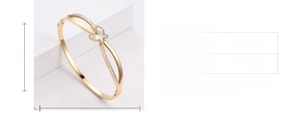 Macro shot of 18K gold butterfly bangle with shell inlay and cubic zirconia stones
