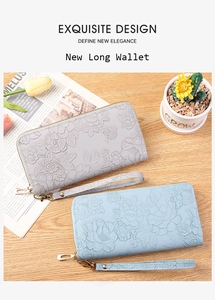 Detailed view of grey and light blue floral embossed leather long wallets with wrist straps