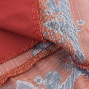 Short sleeve maxi dress featuring ethnic floral print on sheer fabric with rust red lining