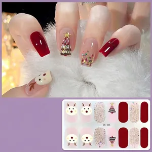 Detailed view of Christmas gel nail stickers with reindeer and tree patterns