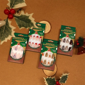 Christmas themed press-on nail sets featuring reindeer and snowflake designs in festive boxes