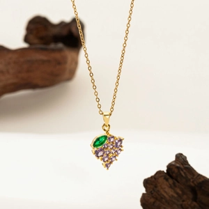 Elegant gold grape cluster necklace with purple cubic zirconia and a green leaf gem