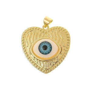 Detailed view of heart shaped golden pendant with blue evil eye zircon center inlay