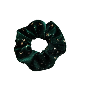 Dark green velvet scrunchie with gold star and moon patterns for Christmas styling