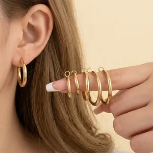 Minimalist gold hoop earring set with various sizes in polished finish for women