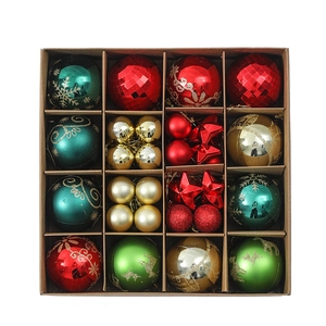 Detail of assorted Christmas tree ornaments with matte and glitter finishes in a gift box