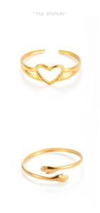 Detailed view of adjustable golden open ring and bracelet with heart and hug designs