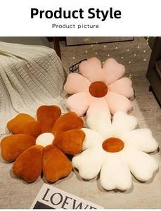 Close-up of soft plush flower cushions in pink and white on a cozy home rug