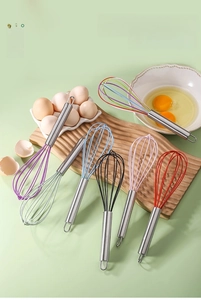 Detail of colorful silicone whisk heads with durable stainless steel handles and hanging loops