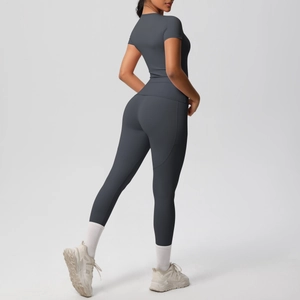 Detail of dark gray high-waisted leggings and compression short sleeve yoga set