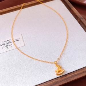 Detailed close-up of a gold-plated rocking horse pendant with micro-set zircon stones