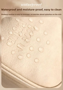 Detail showing waterproof cream leather texture with water drops on cosmetic bag surface