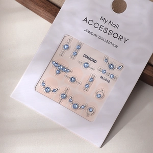 Detail of blue K9 crystal nail art stickers with MJ-019 gemstone designs on display card