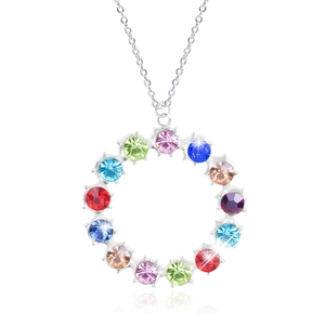 Macro detail of silver-tone circular pendant with fourteen colorful inset crystals