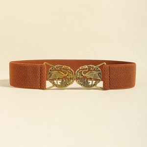 Detail of bronze crane buckle on brown elastic waist belt for dresses and styling