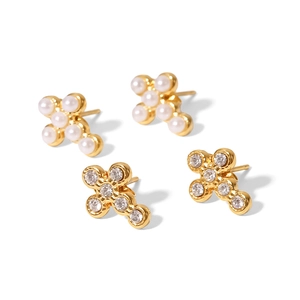 Gold-plated cross earrings set with pearls and crystals on white background
