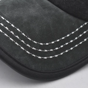 Macro detail of high-density cotton baseball cap brim with triple white stitching