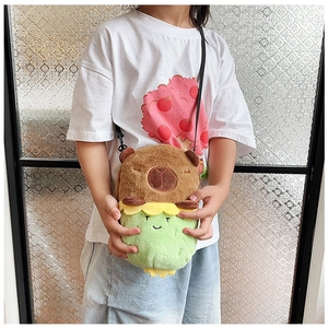 Kid wearing a cute capybara plush crossbody bag with soft brown fur and green detail