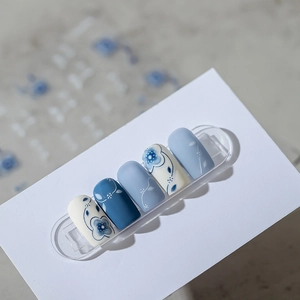 Matte floral nail stickers set with hand-painted blue flowers and dots on white base
