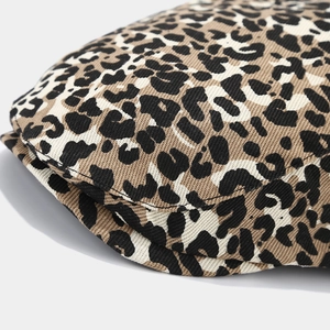 Macro shot of leopard print cotton fabric texture and double-stitched edge on beret hat