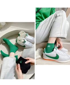 Detailed view of cotton ankle socks featuring NA embroidery in green, white, and black colors