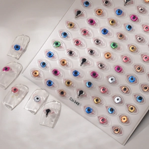 3D evil eye nail art stickers with metallic gold accents and colorful resin eye designs