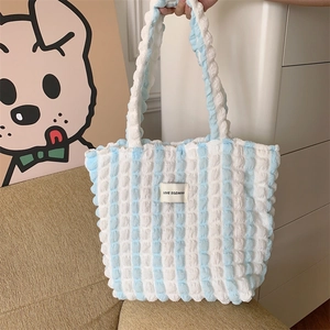 Detailed close-up of blue and white striped bubble texture fabric on a tote bag