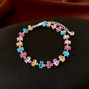 Macro shot of silver bracelet featuring colorful rectangular zircon gemstones and clasp