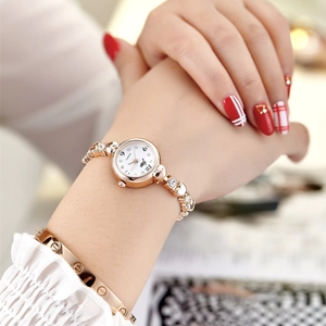 Elegant rose gold women's metal bracelet watch with a minimalist quartz dial on a wrist