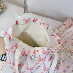 Detail shot of canvas tote interior pocket with inspirational slogan label and floral print