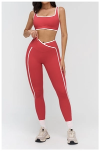 Detail of red and white yoga set featuring a distinctive V-shaped crossover waistband