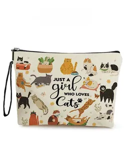 Canvas makeup bag with cute cat prints and a black zipper handle close-up view