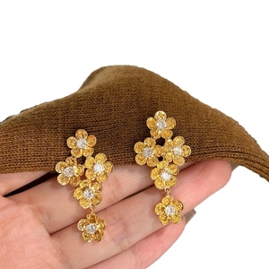 Elegant gold flower drop earrings with sparkling zircon crystals and textured petals