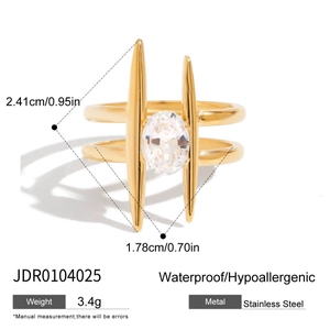 Detail of gold titanium ring featuring oval zircon and sharp spiked decorative design