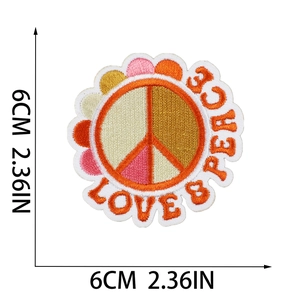 Detailed view of 6cm embroidered peace sign patch with Love & Peace text