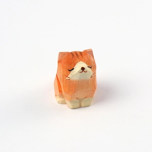 Handcrafted pine wood orange cat figurine with minimalist geometric faceted carving