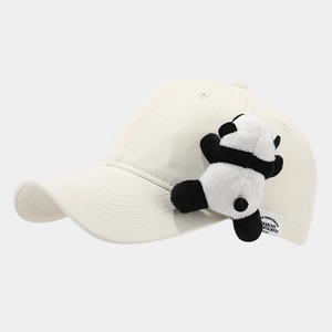 Close-up of cream baseball cap featuring a cute 3D plush panda and detailed stitching