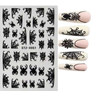 Detail of Halloween nail stickers with black spider and web designs on nails