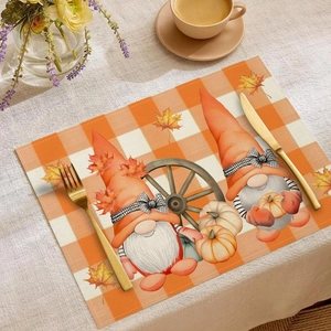 Detailed harvest gnome print on orange checkered placemat with pumpkins and maple leaves