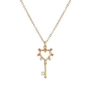 Golden key necklace with heart-shaped cutout pendant and red-pink cubic zirconia gems