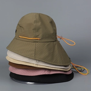 Detail view of colorful nylon hiking hats with adjustable toggles and ripstop fabric texture