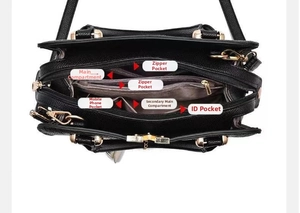 Detailed interior of black litchi leather handbag with multiple compartments and gold zippers