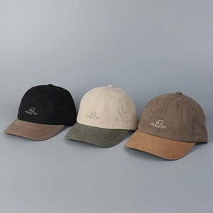 Detailed close-up of three color-block baseball caps with Peaceful embroidery and car icon