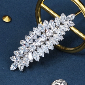 Macro shot of silver leaf hair clip encrusted with sparkling marquise and round zircons