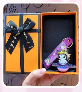 Detail showing cartoon character acrylic oil keyring in a premium gift box