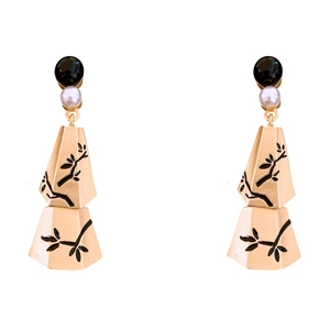Elegant gold pearl drop earrings with black leaf branch pattern and tassels on white background