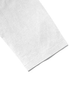 Close-up of white cotton linen fabric showing detailed texture and clean sleeve stitching